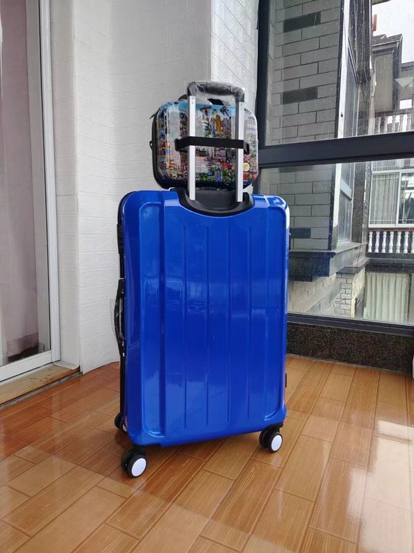 China de alta calidad fábrica colorido nuevo diseño cascarón duro inoxidable regalo conjunto Abs por mayor maleta cremallera tiempo de viaje